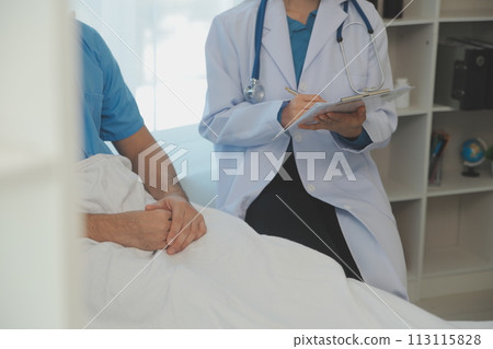 Young doctor is using a stethoscope listen to the heartbeat of the patient. Shot of a female doctor giving a male patient a check up 113115828