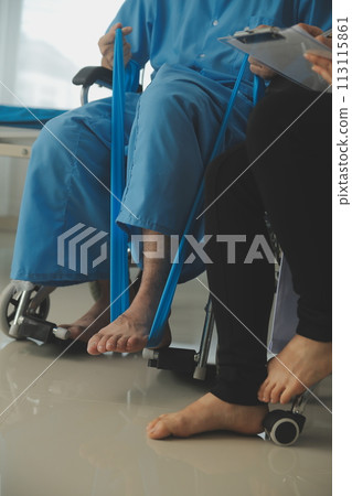 A physiotherapist doing treatment with patient in bright office 113115861