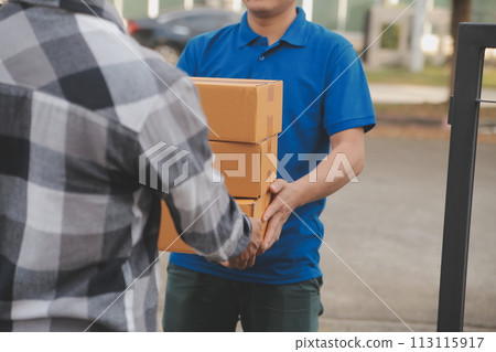 Asian delivery express courier young man use giving boxes to woman customer he wearing protective face mask at front home 113115917