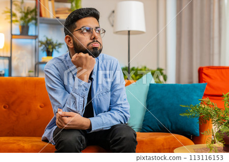 Thoughtful Indian man suffers from unfair situation break up depressed feeling bad annoyed burnout 113116153