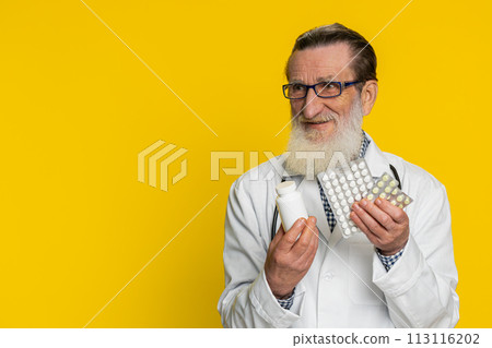 Senior doctor man show lot of tablet pills in blisters recommends drugs vitamin antibiotic treatment 113116202