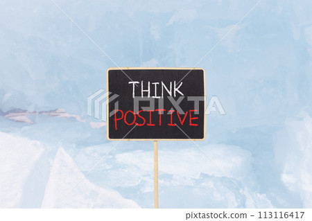 Think positive symbol. Concept words Think positive on beautiful yellow black blackboard. Beautiful blue ice background. Business, motivational think positive thinking concept. Copy space. 113116417