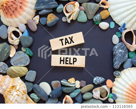 Tax help symbol. Concept words Tax help on wooden blocks on a beautiful black table black background. Sea shell and stone. Business, support and tax help concept. Copy space. 113116565