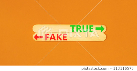 True or fake symbol. Concept word True or Fake on beautiful wooden stick. Beautiful orange table orange background. Business and true or fake concept. Copy space. True or fake symbol. Concept word True or Fake on beautiful wooden stick. Beautiful orange table orange background. Business and true or fake concept. Copy space. 113116573