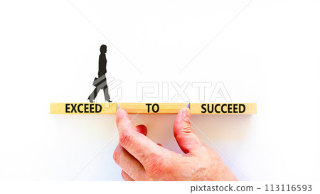 Exceed to succeed symbol. Concept words Exceed to succeed on beautiful wooden blocks. Beautiful white table white background. Businessman hand. Business and exceed to succeed concept. Copy space. 113116593
