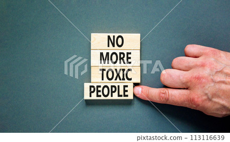 No more toxic people symbol. Concept words No more toxic people on wooden blocks on a beautiful grey table grey background. Psychologist hand. Business, psychological no more toxic people concept. No more toxic people symbol. Concept words No more toxic people on wooden blocks on a beautiful grey table grey background. Psychologist hand. Business, psychological no more toxic people concept. 113116639
