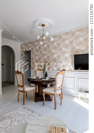 House with wooden furniture in living room table, chairs, and TV 113116780