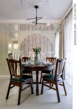 Furniture set with table, chairs, chandelier in buildings dining room 113116794