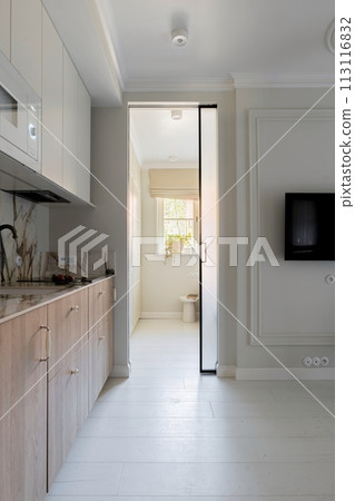 a kitchen with a sliding glass door leading to a living room a kitchen with a sliding glass door leading to a living room 113116832