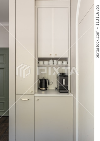 White cabinetry, coffee maker, and kettle in a kitchen White cabinetry, coffee maker, and kettle in a kitchen 113116855