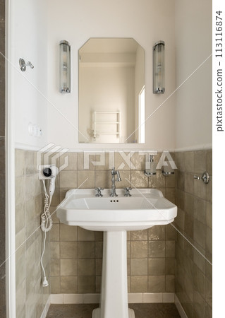 Bathroom with pedestal sink, mirror, and hair dryer Bathroom with pedestal sink, mirror, and hair dryer 113116874