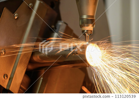 Close up scene the fiber laser cutting machine cut the stainless steel tube and sparkling light. 113120539