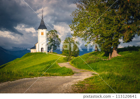 Winding rural road and Saint Primoz mountain church, Jamnik, Slovenia Winding rural road and Saint Primoz mountain church, Jamnik, Slovenia 113120641