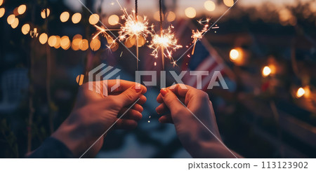Two hands holding sequins with warm glowing lights on the background of the American flag. Two hands holding sequins with warm glowing lights on the background of the American flag. 113123902