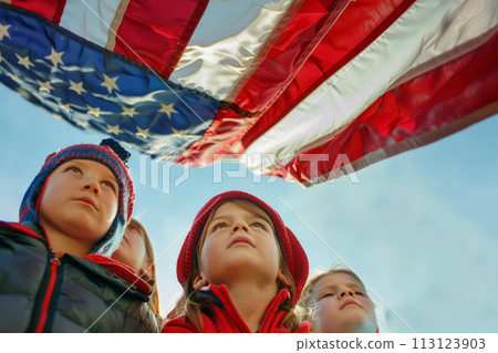 Children looking up at the American flag on Independence Day. Children looking up at the American flag on Independence Day. 113123903