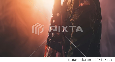 Silhouette of a military person holding the American flag. Silhouette of a military person holding the American flag. 113123904