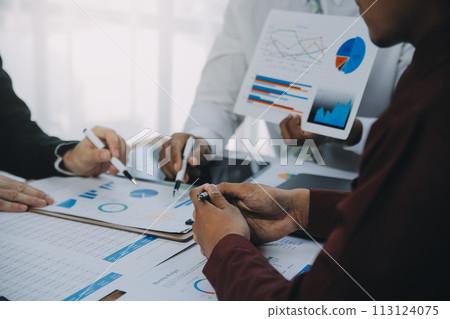 Business team working with new startup project plan and discussion information for financial strategy with laptop and digital tablet in a modern business lounge. 113124075