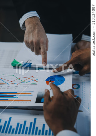Business idea. Business people talking And calculations about charts and graphs showing the growth of investment results Of successful teamwork Business idea. Business people talking And calculations about charts and graphs showing the growth of investment results Of successful teamwork 113124097