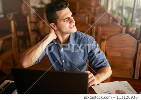 Businessman with backpain after long hours at work rubbing his neck because of ache. Overworked handsome freelancer man with scoliosis working with laptop. Health problems theme. Businessman with backpain after long hours at work rubbing his neck because of ache. Overworked handsome freelancer man with scoliosis working with laptop. Health problems theme. 113126930