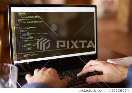 Back view over the shoulder shot of developer programmer with laptop. Program code and script data on the screen. Young freelancer in glasses working on project in cafe. Back view over the shoulder shot of developer programmer with laptop. Program code and script data on the screen. Young freelancer in glasses working on project in cafe. 113126974