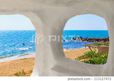 Beach at World's End Park, Sanya, China. View of the beautiful beach and sea from the white bungalow 113127472