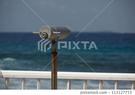 Beach guard telescope looking out towards sea views on surfer spot on Maldives Beach guard telescope looking out towards sea views on surfer spot on Maldives 113127753