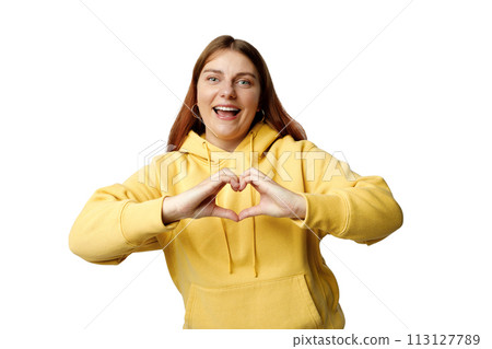 Attractive 30s brunette young woman feels happy and romantic shapes heart gesture expresses tender feelings poses against white background. Attractive 30s brunette young woman feels happy and romantic shapes heart gesture expresses tender feelings poses against white background. 113127789