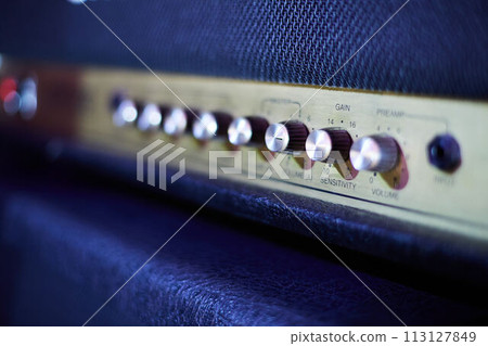 Guitar amplifier, level knobs closeup shot. Electric guitar amp closeup photo for rock music. Guitar amplifier, level knobs closeup shot. Electric guitar amp closeup photo for rock music. 113127849