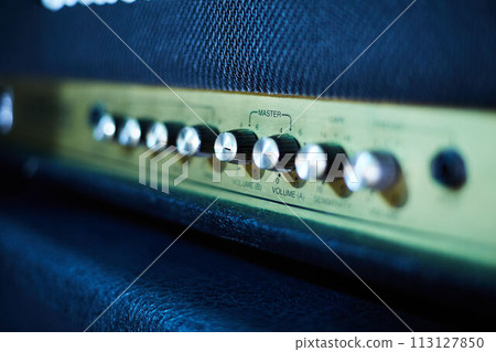 Guitar amplifier, level knobs closeup shot. Electric guitar amp closeup photo for rock music. Guitar amplifier, level knobs closeup shot. Electric guitar amp closeup photo for rock music. 113127850