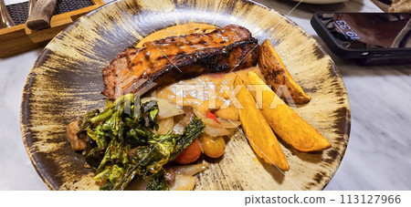 New york strip loin beef steak meat with mushroom sauce and potato wedges and salad plated on beautiful plate 113127966