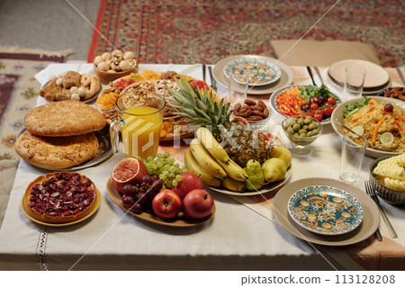 High angle view no people shot of Uraza Bayram festive table set with various dishes in living room, copy space 113128208