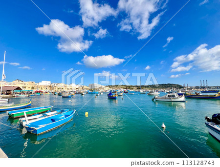 Fishing boats in the harbor of Marsaxlokk, Malta in a beautiful sunny day 113128743