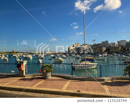 Fishing boats in the harbor of Marsaxlokk, Malta in a beautiful sunny day 113128744
