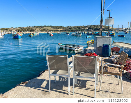 Fishing boats in the harbor of Marsaxlokk, Malta in a beautiful sunny day Fishing boats in the harbor of Marsaxlokk, Malta in a beautiful sunny day 113128902