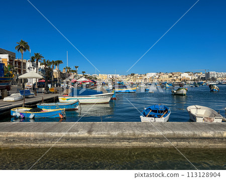 Fishing boats in the harbor of Marsaxlokk, Malta in a beautiful sunny day Fishing boats in the harbor of Marsaxlokk, Malta in a beautiful sunny day 113128904
