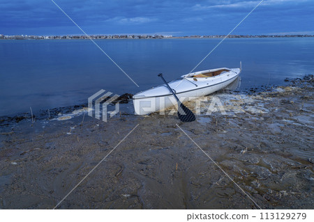 decked expedition canoe on a calm lake at dusk in Colorado - Boyd Lake State Park 113129279