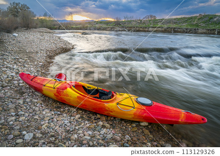 whitewater kayak and river rapid at sunset - Cache la Poudre River in Fort Collins, Colorado 113129326