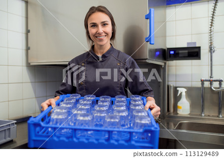 Woman with clean glasses preparing for event in restaurant Woman with clean glasses preparing for event in restaurant 113129489