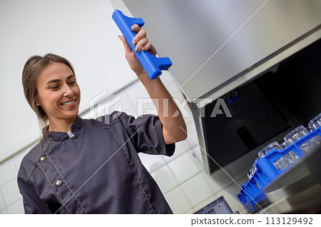 Woman with clean glasses preparing for event in restaurant 113129492