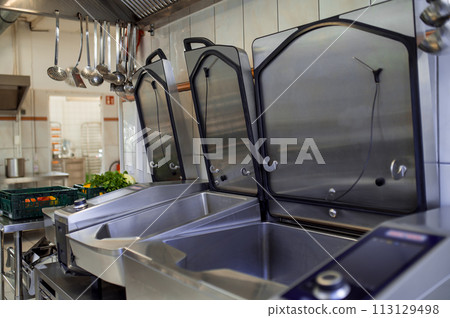 Industrial dishwasher in restaurant kitchen washing dishes Industrial dishwasher in restaurant kitchen washing dishes 113129498