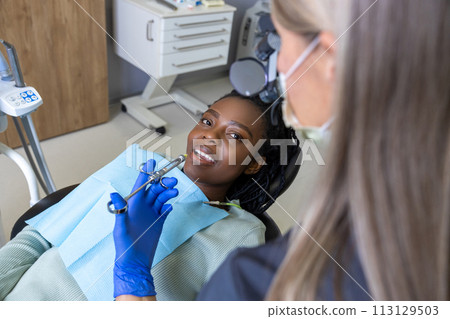 Dentist surgeon injecting anesthesia to patient Dentist surgeon injecting anesthesia to patient 113129503