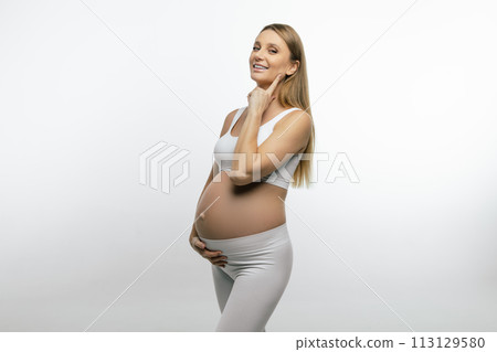 Pretty pregnant blonde woman feeling happy and joyful Pretty pregnant blonde woman feeling happy and joyful 113129580