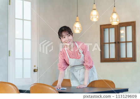 Female clerk working at a cafe 113129609