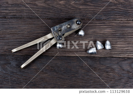 Antique old west bullet mold with bullets for revolver. 113129638