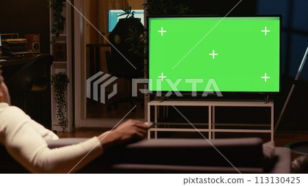 African american man using streaming services on mockup TV to binge watch series from the comfort of his apartment. Person enjoying shows on isolated screen television set during leisure time on couch African american man using streaming services on mockup TV to binge watch series from the comfort of his apartment. Person enjoying shows on isolated screen television set during leisure time on couch 113130425