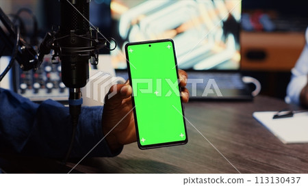 Isolated screen smartphone hold by presenter on podcast discussing with guest during marathon stream for humanitarian cause. Mockup mobile phone used by host to check gathered donations from audience 113130437