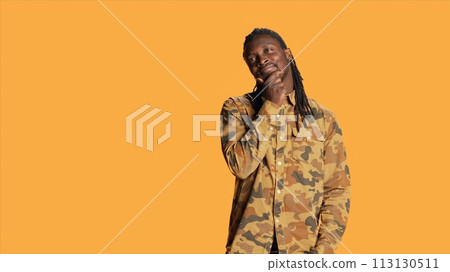 African american pensive guy acting unsure and clueless, posing on camera with doubt and feeling confused. Young adult being contemplative and puzzled, expressing confusion and uncertainty. 113130511