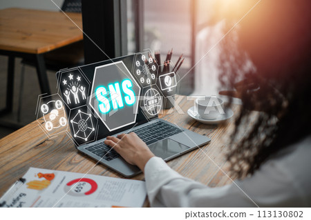 SNS, Social Networking Service concept, Businesswoman using laptop computer on office desk with Social Networking Service icon on virtual screen. 113130802