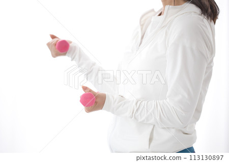 Middle-aged woman doing muscle training with dumbbells Middle-aged woman doing muscle training with dumbbells 113130897