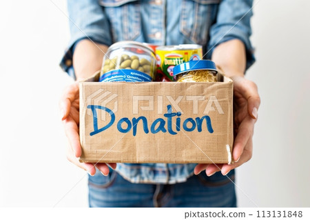 Donation concept. A person is holding a box that says donation on it 113131848